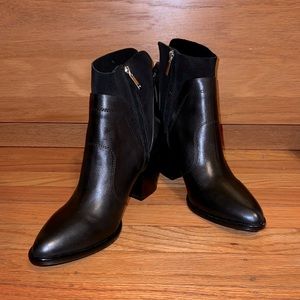 Black Marc Fisher Western Style bootie with tassels on heels.